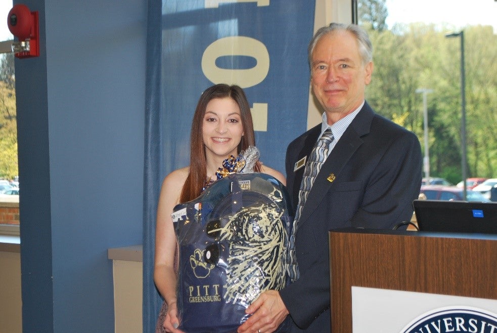 Amanda Stein ‘19 is presented a Pitt spirit basket from PGAA president James Smith at the 2019 Commencement Breakfast in celebration of her family’s 9th Pitt degree