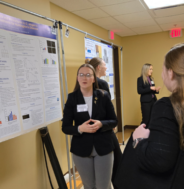 Student making a poster presentation.