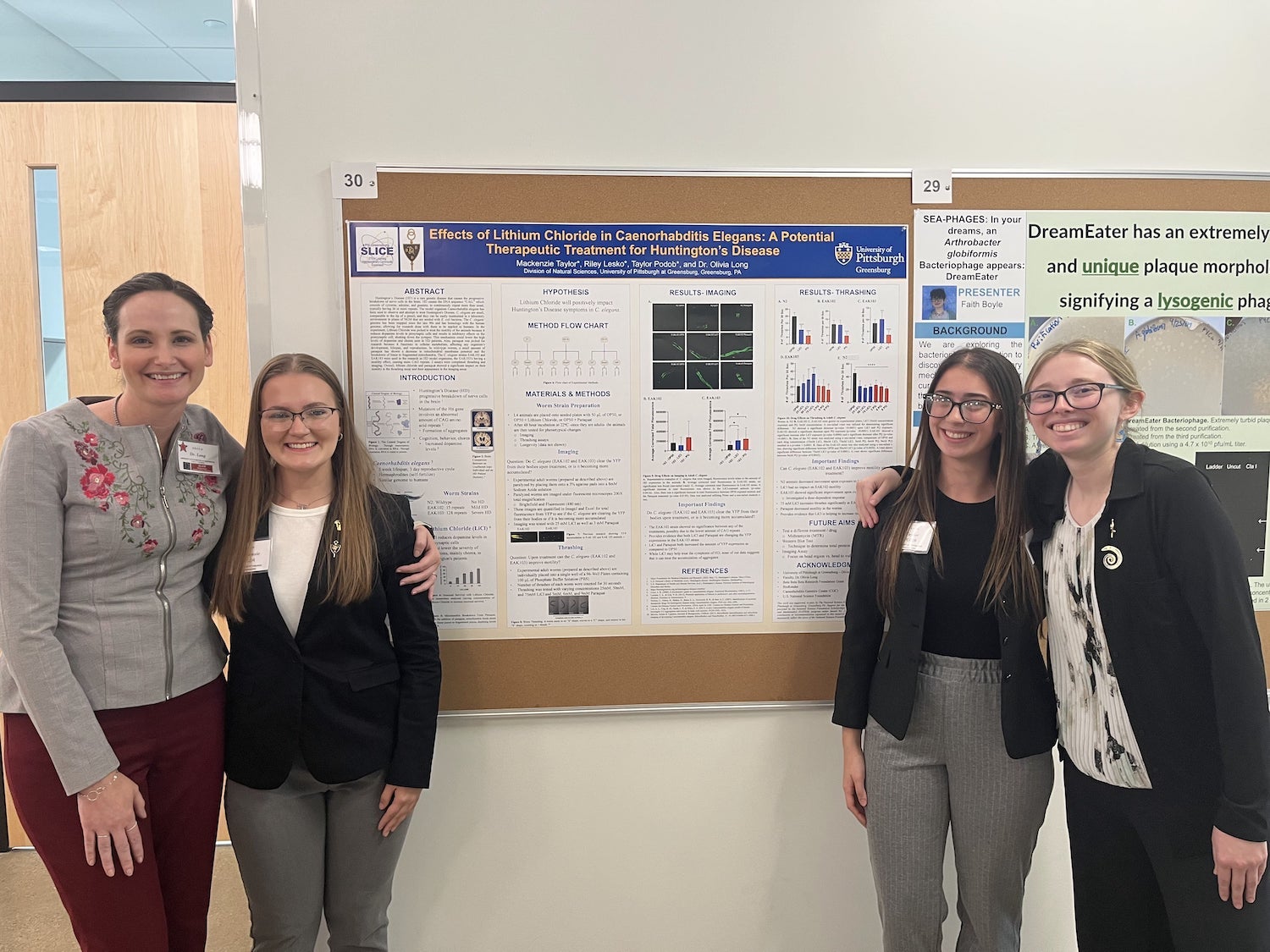 Dr. Olivia Long congratulates her students on their first-place poster presentation