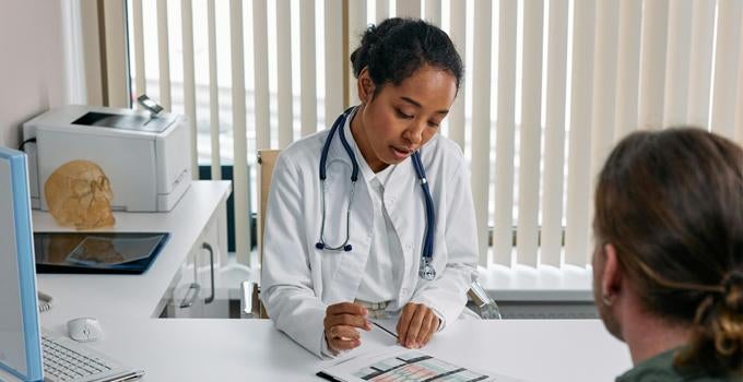 doctor speaking to a patient in an office