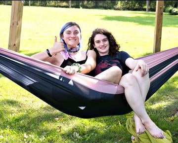 Students share a hammock on the Greensburg campus.