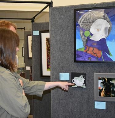Visitors viewing art during the Artists Reception at the Art Show @ Pitt-Greensburg